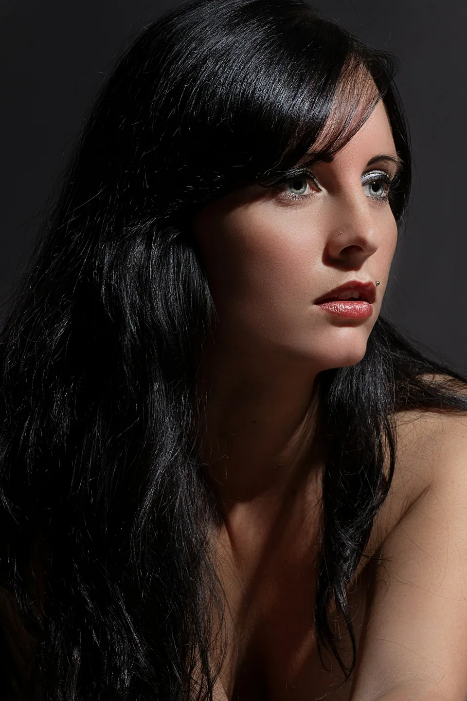 Glossy black hair styled with a soft fringe