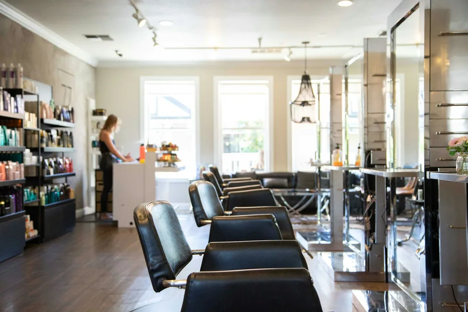 A welcoming, sunlit salon with comfortable styling chairs
